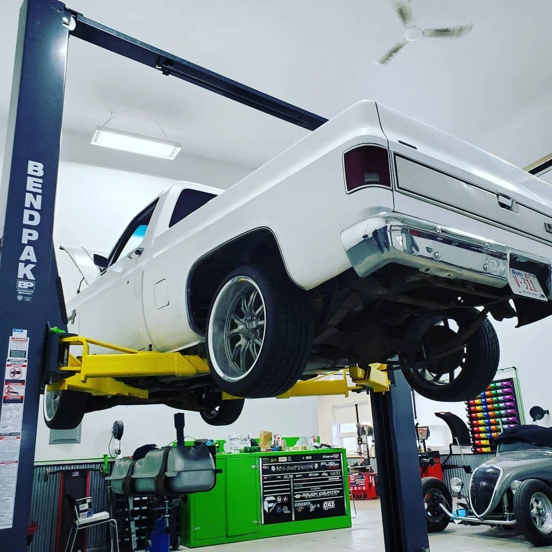 Classic truck on a lift in the Camo Tow shop