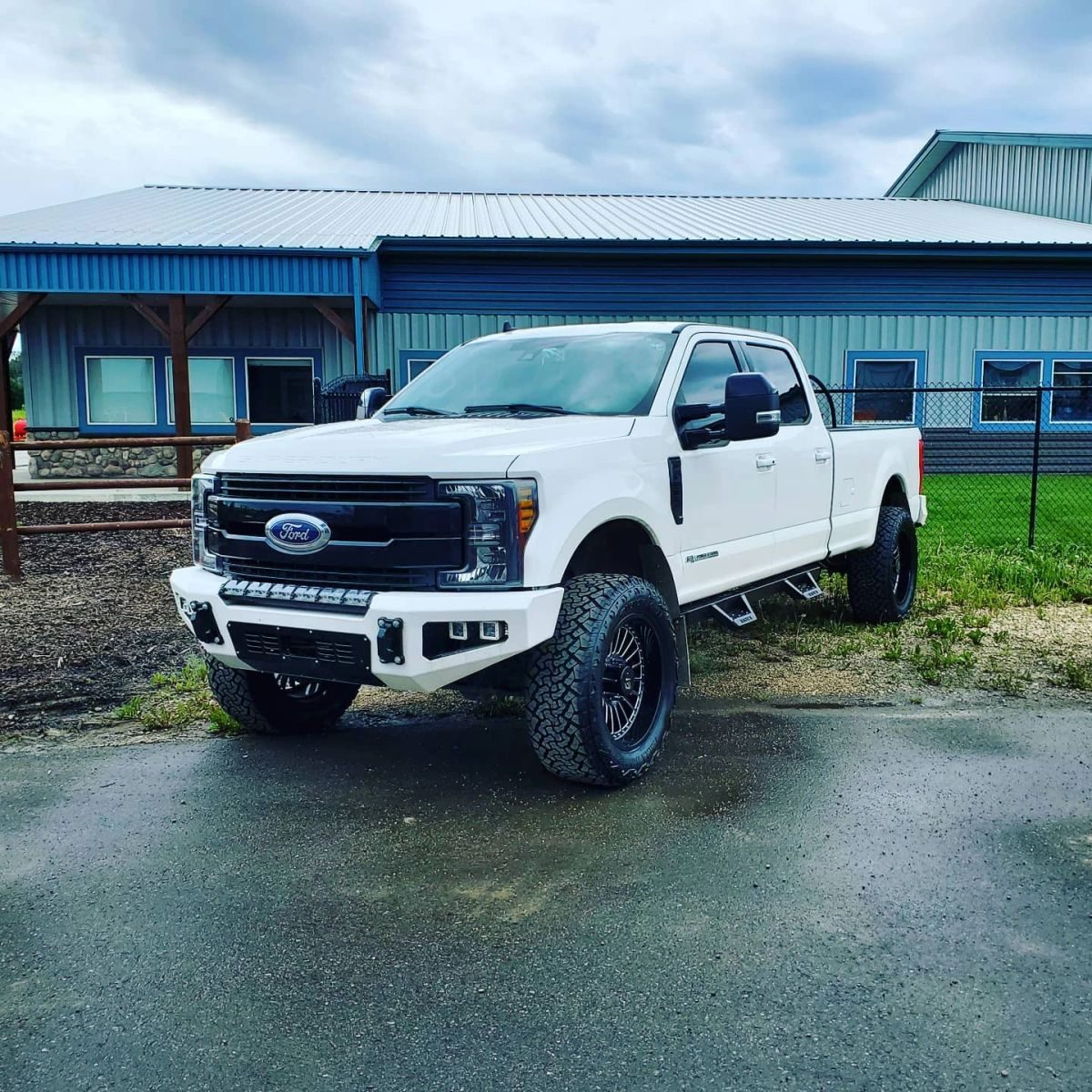White Ford pickup outside the shop