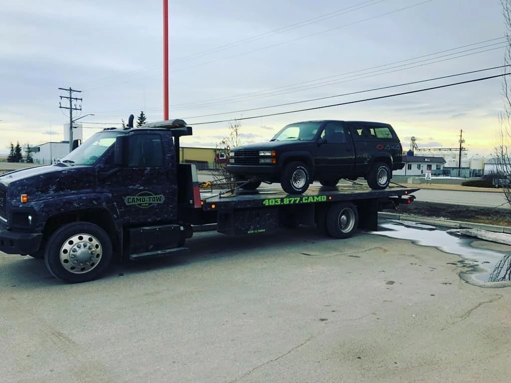 Camo Tow truck on the road