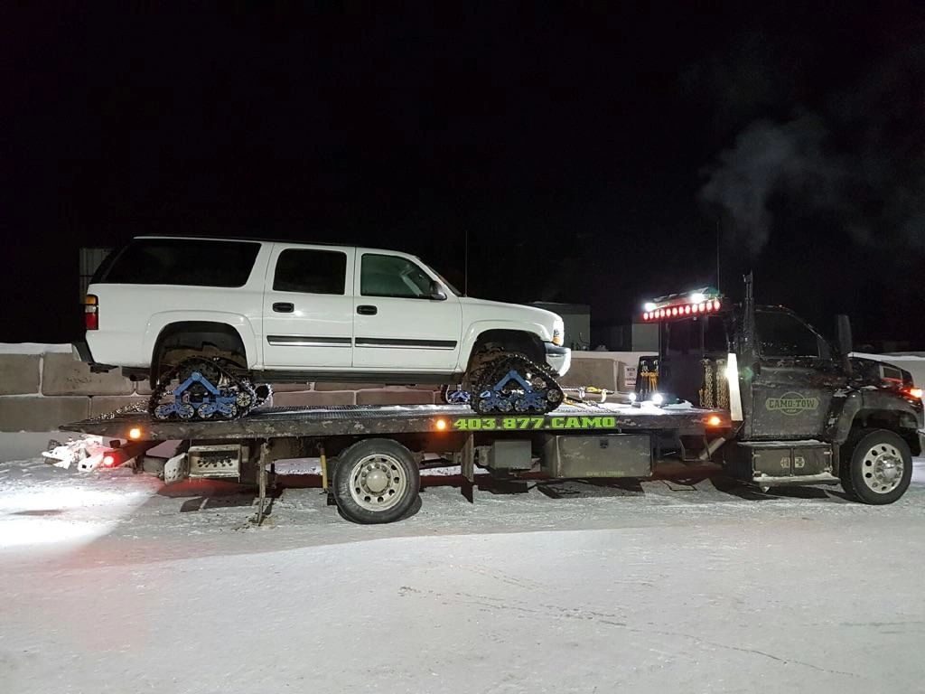 Camo Tow hauling an SUV at night